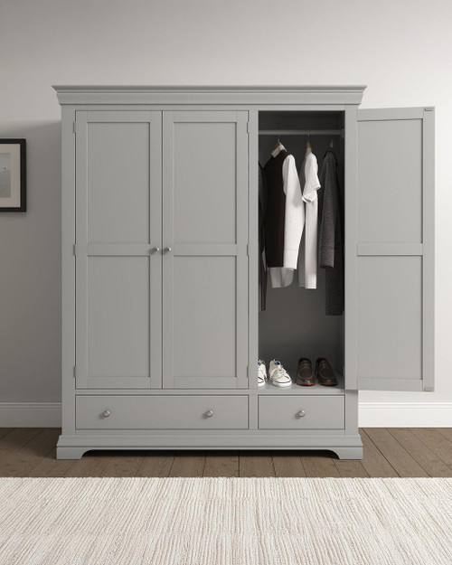 Vermont 3 Door Wardrobe in Pebble Grey VM100-101-234, a modern wardrobe with three doors, including a partially open door revealing hanging clothes and shoes inside.