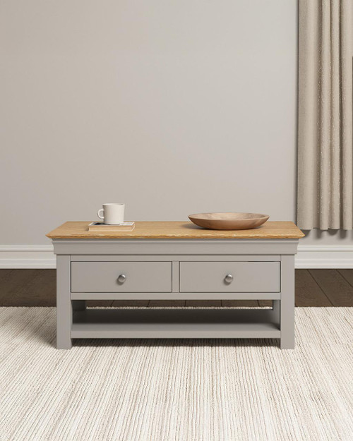 Vermont 2 Drawer Coffee Table, wooden coffee table with gray finish and natural wood top, featuring two drawers and lower shelf in a cozy living room setting.