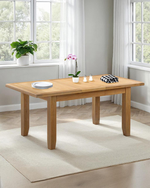 Hampton Oak Extending Dining Table HO400-403-075, wooden dining table with a natural oak finish placed in a bright room with large windows and white curtains. Hampton Oak Extending Dining Table HO400-403-075, wooden dining table with a natural oak finish placed in a bright room with large windows and white curtains.