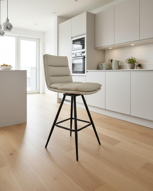 Hamilton Swivel Counter Chair in Truffle, a modern beige cushioned bar stool with black metal legs and a footrest, in a minimalist white kitchen setting. Hamilton Swivel Counter Chair in Truffle, a modern beige cushioned bar stool with black metal legs and a footrest, in a minimalist white kitchen setting.