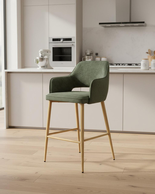 Stanley Green Bar Chair, green upholstered bar stool with wooden legs in modern kitchen setting. Stanley Green Bar Chair, green upholstered bar stool with wooden legs in modern kitchen setting.