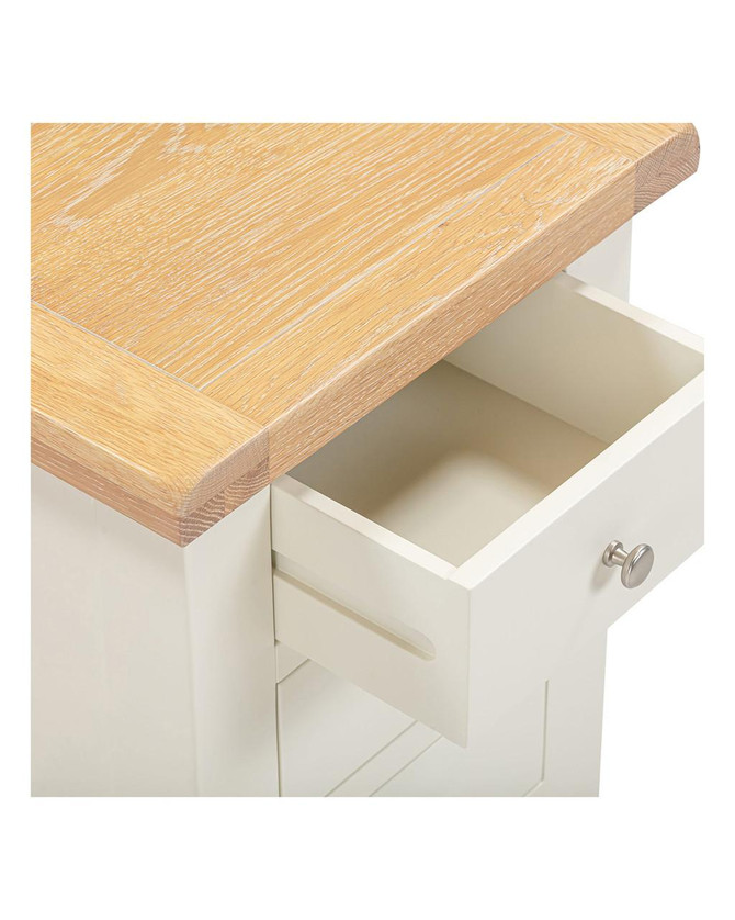 Hampton Ivory 3 Drawer Bedside, close-up image showing the light wood top and white drawer with a round metallic handle.