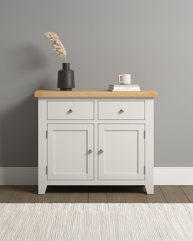 Hampton Ivory 2 Door 2 Drawer Sideboard HI400-405-048, a white wooden sideboard with a natural wood top, featuring two drawers and two cabinet doors.