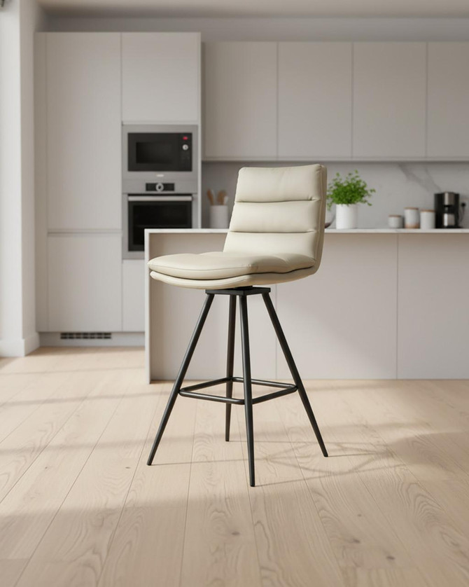 Hamilton Swivel Counter Chair in Truffle, a modern beige leather swivel counter chair with black metal base and footrest, in a contemporary kitchen setting, sold as a pair.