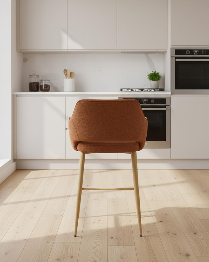 Stanley Rust Coloured Bar Chair, pair, modern design with rust-colored upholstered seat and light wooden legs in a minimalist kitchen setting. Stanley Rust Coloured Bar Chair, pair, modern design with rust-colored upholstered seat and light wooden legs in a minimalist kitchen setting.