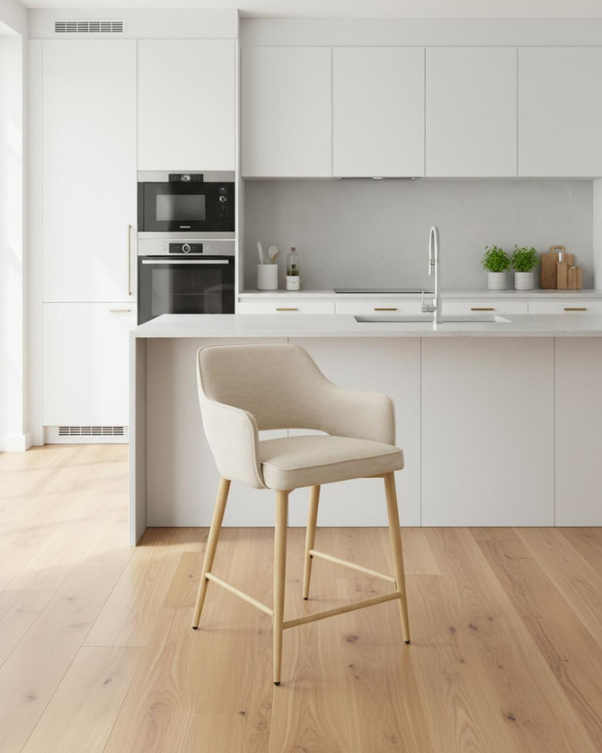 Stanley Natural Kitchen Counter Chair, pair of beige upholstered chairs with light wooden legs placed in a modern white kitchen with minimalist design and light wood flooring. Stanley Natural Kitchen Counter Chair, pair of beige upholstered chairs with light wooden legs placed in a modern white kitchen with minimalist design and light wood flooring.