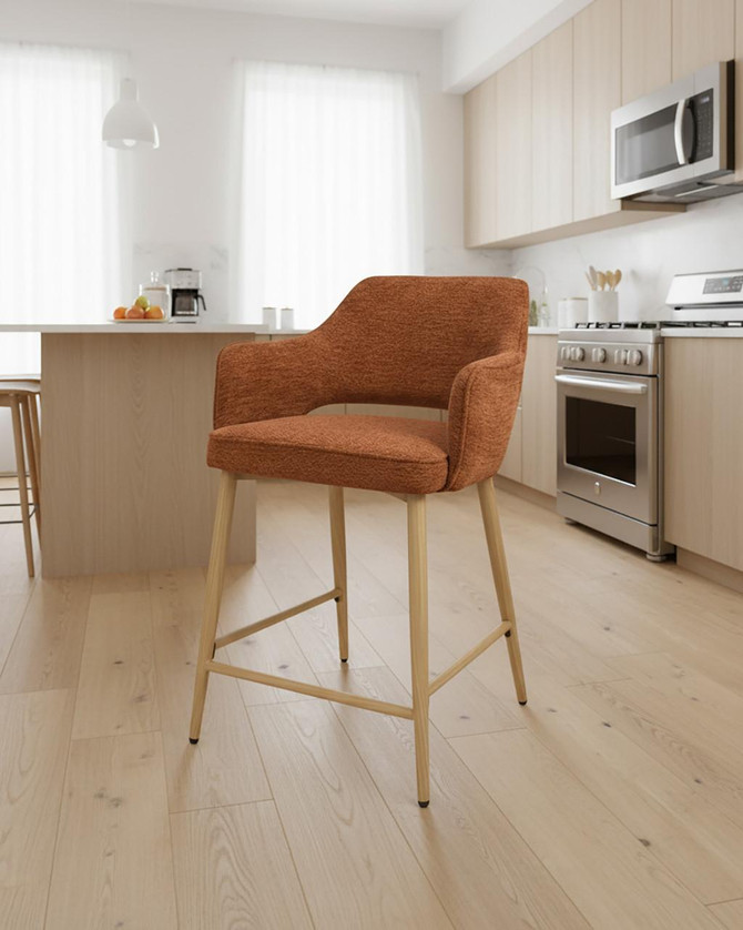 Stanley Rust Coloured Kitchen Counter Chair, sold as a pair, in an orange-brown textured fabric with light wooden legs in a modern kitchen setting. Stanley Rust Coloured Kitchen Counter Chair, sold as a pair, in an orange-brown textured fabric with light wooden legs in a modern kitchen setting.
