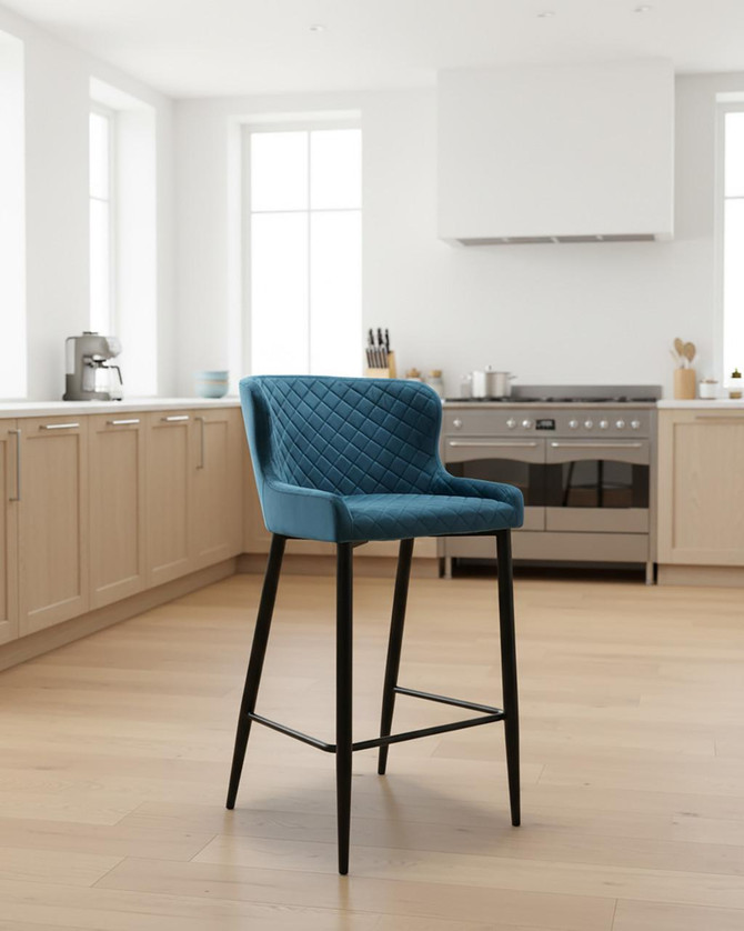 Roma Bar Stool in Blue, pair of modern upholstered bar stools with quilted pattern and black legs in a bright kitchen setting