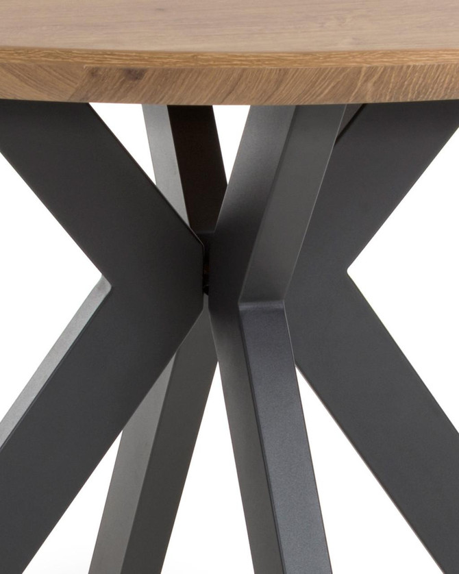 Hamilton Rustic Oak 120cm Round Table, close-up view of the table's wooden top and black metal X-shaped legs.