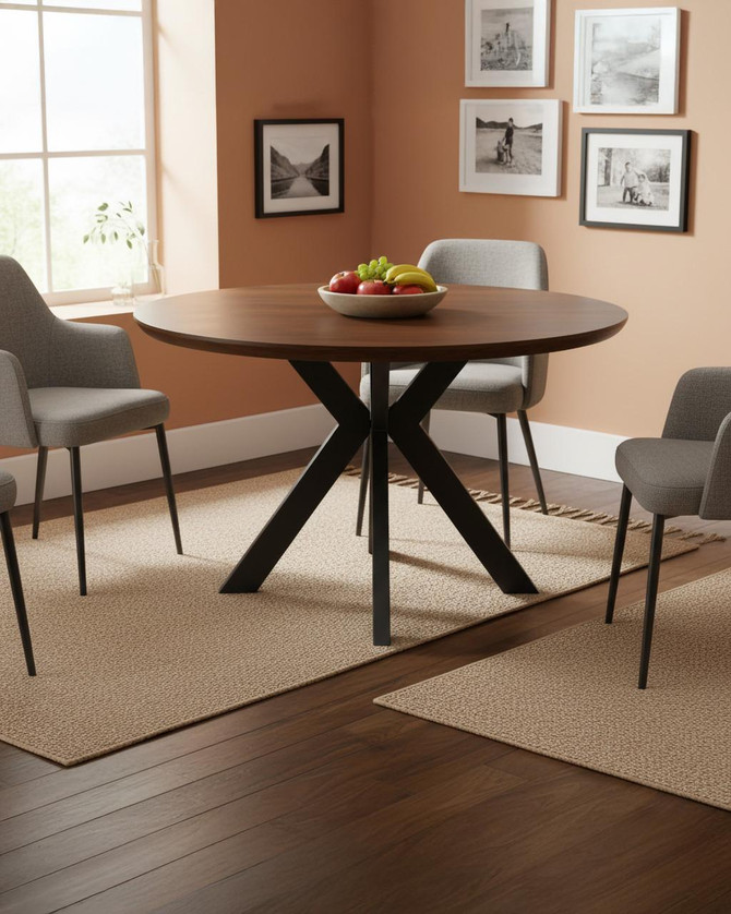 Hamilton Smoked Oak 120cm Round Table, modern round dining table with smoked oak finish and black X-shaped legs in a cozy dining room with gray chairs and wall art.