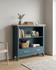 Anchorage Blue Low Bookcase WFS-BH-ANC01A, blue wooden bookcase with two open shelves and two drawers at the bottom, featuring a natural wood top surface.