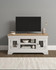 Vermont Small TV Stand in Ivory/Oak VM300-305-064, showcasing a sleek white design with a wooden top, glass-paneled cabinet doors, and open shelves, holding decor and books.