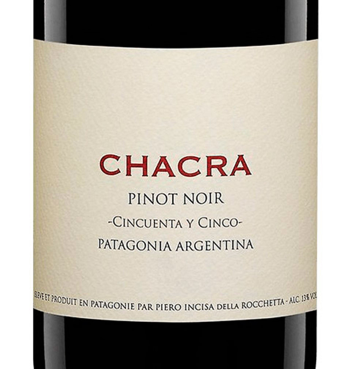 Close-up of Chacra Pinot Noir bottle with a beige label reading