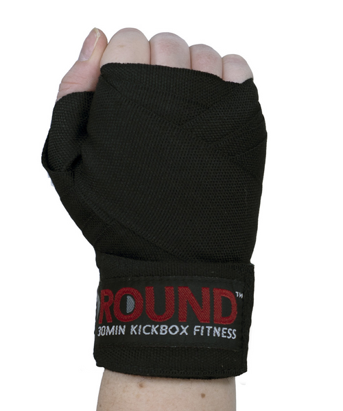 A hand held in the air in a fist with the back of the hand facing you and wearing a solid black boxing hand wrap A hand held in the air in a fist with the back of the hand facing you and wearing a solid black boxing hand wrap