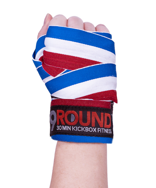 A hand held in the air in a fist with the palm of the hand facing you and wearing red, white, and blue striped hand wrap A hand held in the air in a fist with the palm of the hand facing you and wearing red, white, and blue striped hand wrap