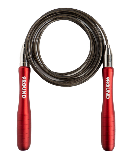 A flat lay image of a jump rope with a black cord and red metal handles with a white 9Round logo
