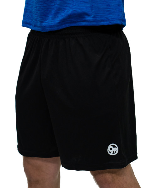 A person wearing a blue shirt and black athletic shorts with a white logo on the lower left leg.