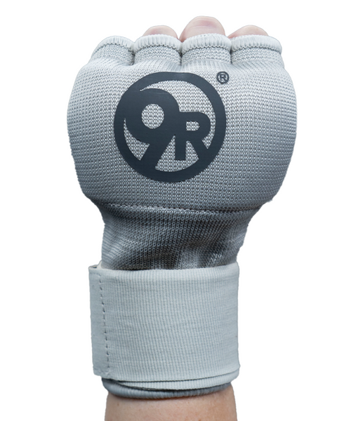 A hand wearing a gray boxing speed wrap with black 9R logo, featuring padded knuckles and a wrist strap for support.
