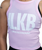 A close up of a woman's cropped pink tank top with a big white ILKB (iLoveKickboxing) on the front