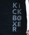 a close up of a black shirt with a gery design that reads kickboxer