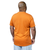 A man facing away from view showing the back of an orange t-shirt