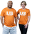 A man and a woman both wearing the same orange t-shirt that reads ILKB I love Kickboxing