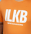 A close up of the logo on an orange t-shirt that reads ILKB I Love Kickboxing