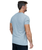 A man in a grey t-shirt facing away from the camera showing the back of the shirt, which is plain