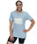 A woman smiling at the camera in grey unisex t-shirts that say "unleash the beast" in white text with yellow claw mark design behind it and an I Love Kickboxing logo underneath