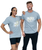 A man and a woman both smiling at the camera in grey unisex t-shirts that says "unleash the beast" in white text with yellow claw mark design behind it and an I Love Kickboxing logo underneath