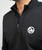 A close up of a black quater-zip sweatshirt with a white 9Round circle logo on the upper right-hand side
