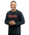 A young adult male in a long-sleeve black and grey acid wash t-shirt with a red 9Round logo on the front center