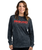 A middle-aged adult woman in a long-sleeve black and grey acid wash t-shirt with a red 9Round logo on the front center