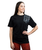 A young adult woman wearing a black oversized t-shirt with three grey 9Round logos printed in a modern design on the upper right-hand shoulder