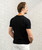 A back view of a male wearing a black t-shirt