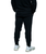 A bottom view of a pair of black joggers or sweatpants on a young adult male viewed from the back