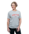 A young adult women wearing a grey t-shirt that reads "Kick It Up" in red text