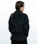 The back view of a man wearing a black fleece zip-up jacket