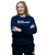 Woman with long blonde hair smiling, standing with arms crossed, wearing a navy blue sweatshirt that says I LOVE KICKBOXING and matching sweatpants, on a white background.