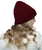 A young woman with blonde hair wearing a natural t-shirt and burgundy cable knit beanie