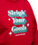 Red sweatshirt with the phrase “Sleigh Your Goals” in green and white letters, along with “I Love Kickboxing” printed underneath.