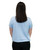 A person with straight brown hair is standing with their back to the camera, wearing a light blue t-shirt and black pants against a white background.