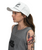 Woman in a gray sleeveless shirt with text, wearing a white cap, has long brown hair and a colorful bird tattoo on her upper arm, facing left.