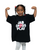 Young girl with braided hair flexes her arms and smiles, wearing an oversized black t-shirt with the text JAB CROSS PLAY printed on the front.