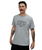 A man with tattoos on his arms wears a light gray T-shirt that says STRONGER EVERY DAY and 9ROUND, standing against a plain white background.