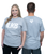 Two people model a gray t-shirt; the front displays ILKB I LOVE KICKBOXING and the back features a small heart with ILKB inside it near the neckline.