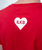 Person wearing a red shirt with a white heart shape containing the letters ILKB on the back.
