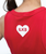 Person wearing a red shirt with a white heart shape containing the letters ILKB on the back.
