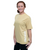 A woman stands smiling, wearing a light gold 9ROUND t-shirt and black pants against a white background.