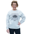 Woman standing and smiling, wearing a light gray sweatshirt with JAB CROSS HOOK repeated in a square pattern and 9ROUND printed below, paired with black leggings.